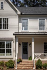 A close-up view of the front entrance to a house with a brick staircase leading up to the front door