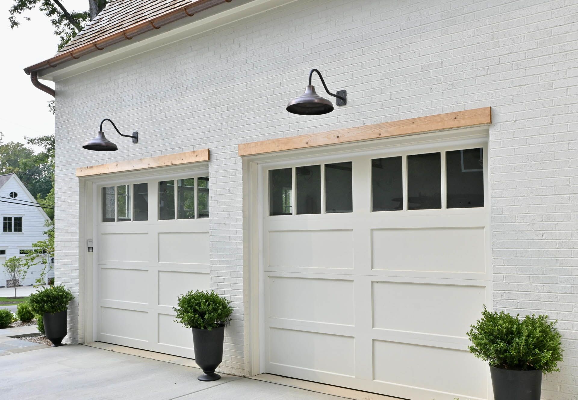 A white house with two garage doors