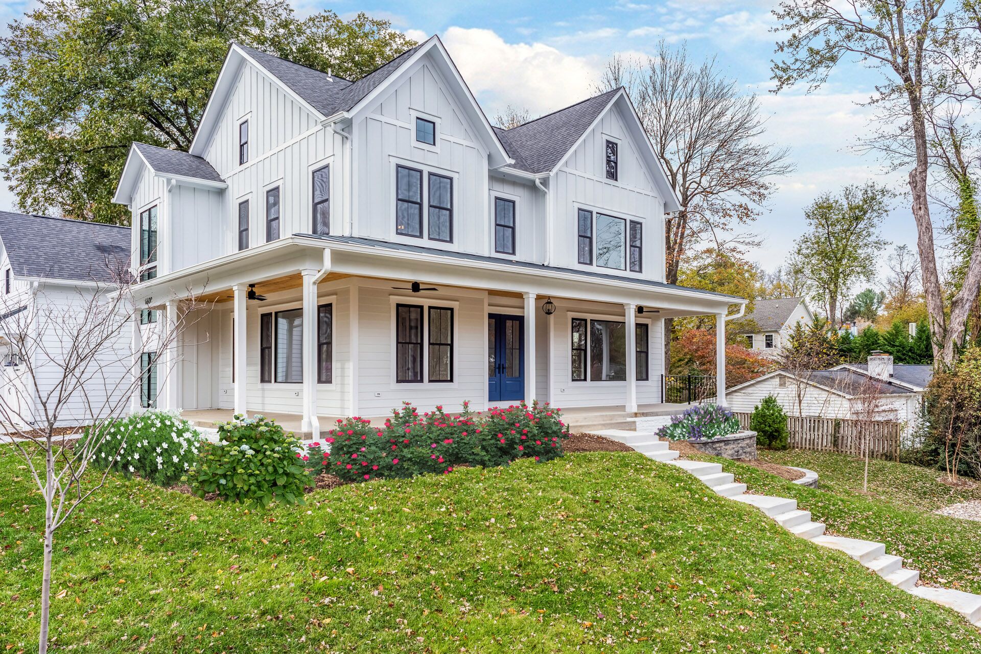 A white house with a white staircase leading up to the front porch