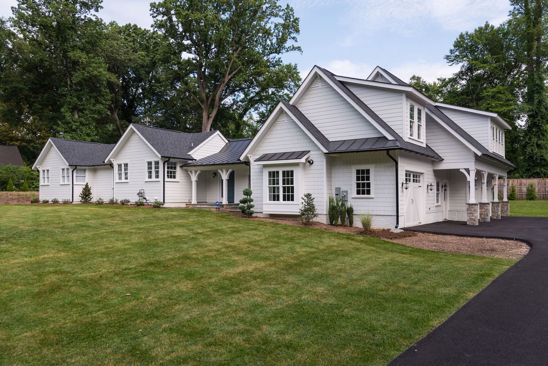 A white house with a clean-cut green front lawn