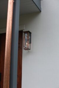 A close-up view of the entrance to a home with a porch light