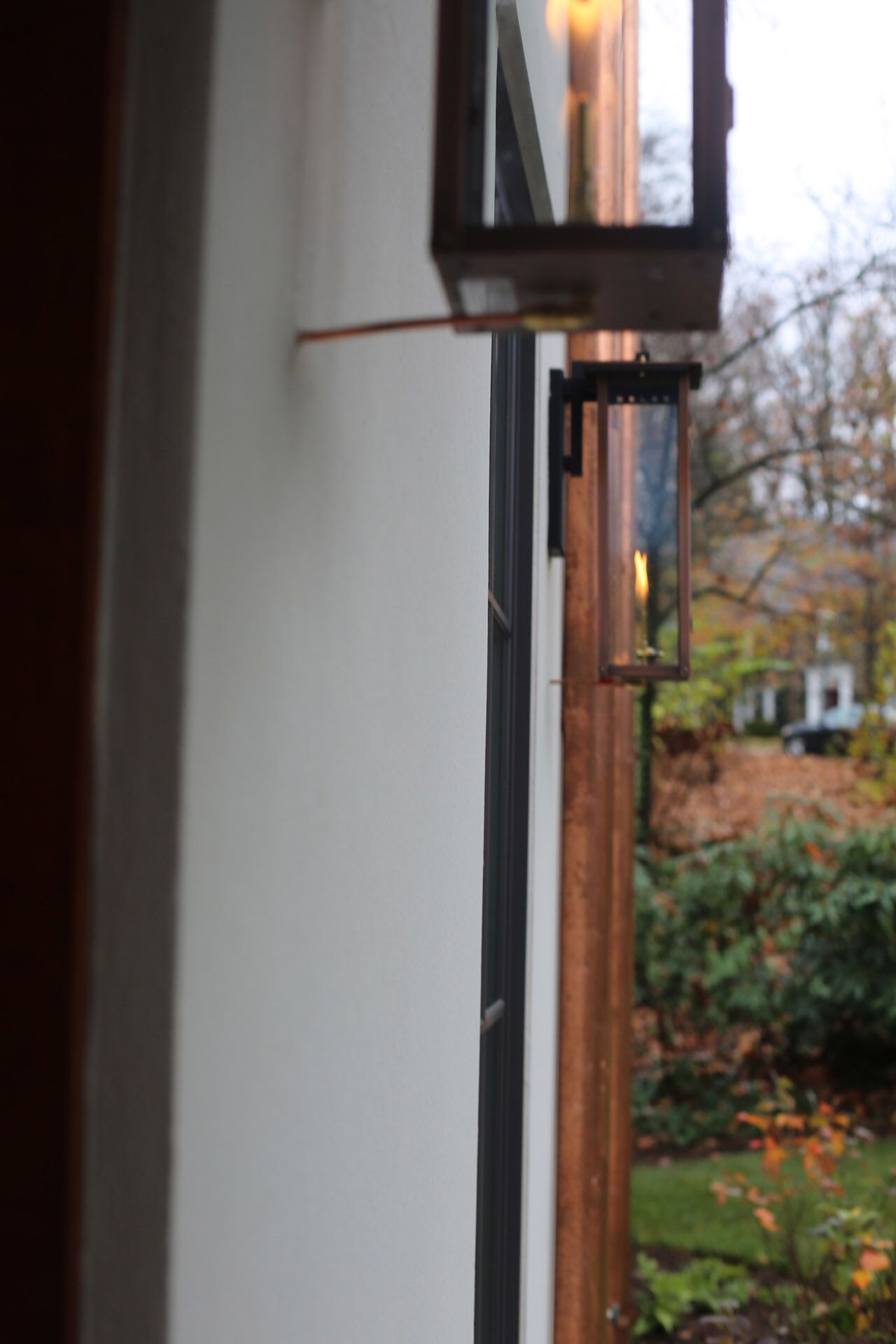 A close-up view of a porch light at the front door of a house